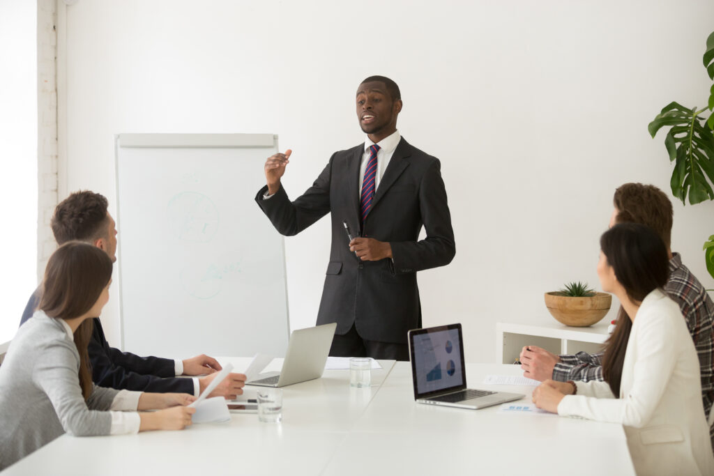 Confident African Speaker Business Coach Giving Presentation Team 1024x683